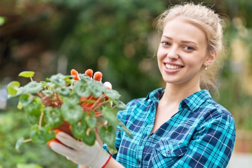 Close-up of a technician inspecting lawn edging after mowing